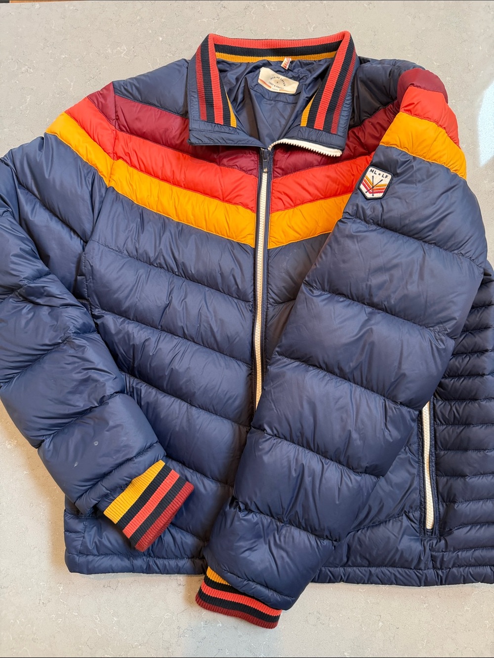Marine Layer Navy Puffer Jacket with Red & Yellow Chevron
